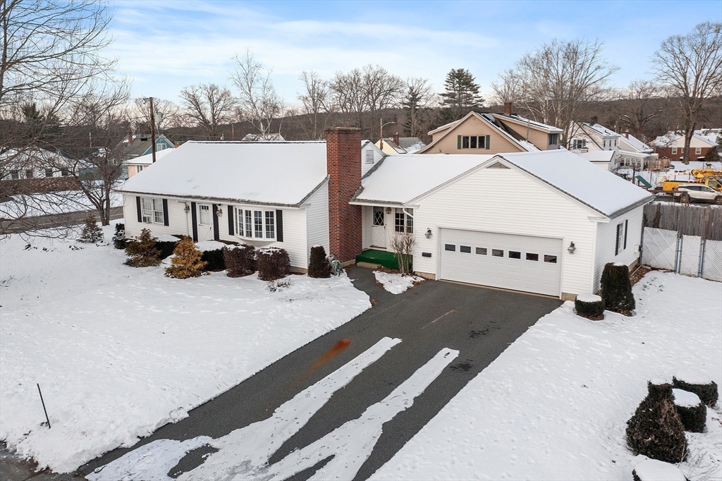 a view of a white house with a yard covered in snow