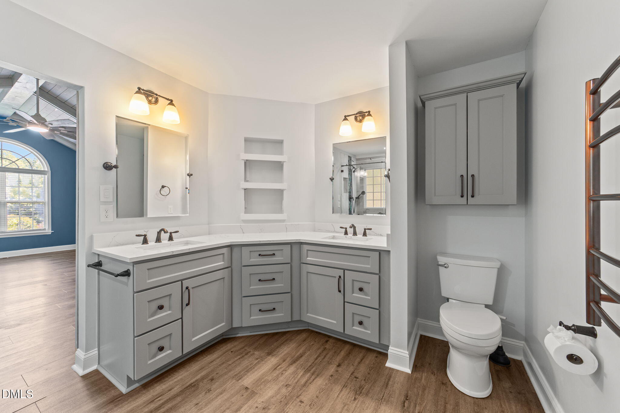 6820 Oviedo Drive Raleigh, NC 27603 - Photo 26 of 50 a spacious bathroom with a toilet a double vanity sink a mirror and a window