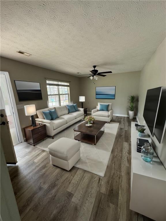 1727 Oak Grove Church Road, Unit B Carrollton, GA 30117 - Photo 1 of 13 a living room with furniture and a flat screen tv