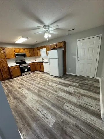 a view of a room with furniture and a ceiling fan