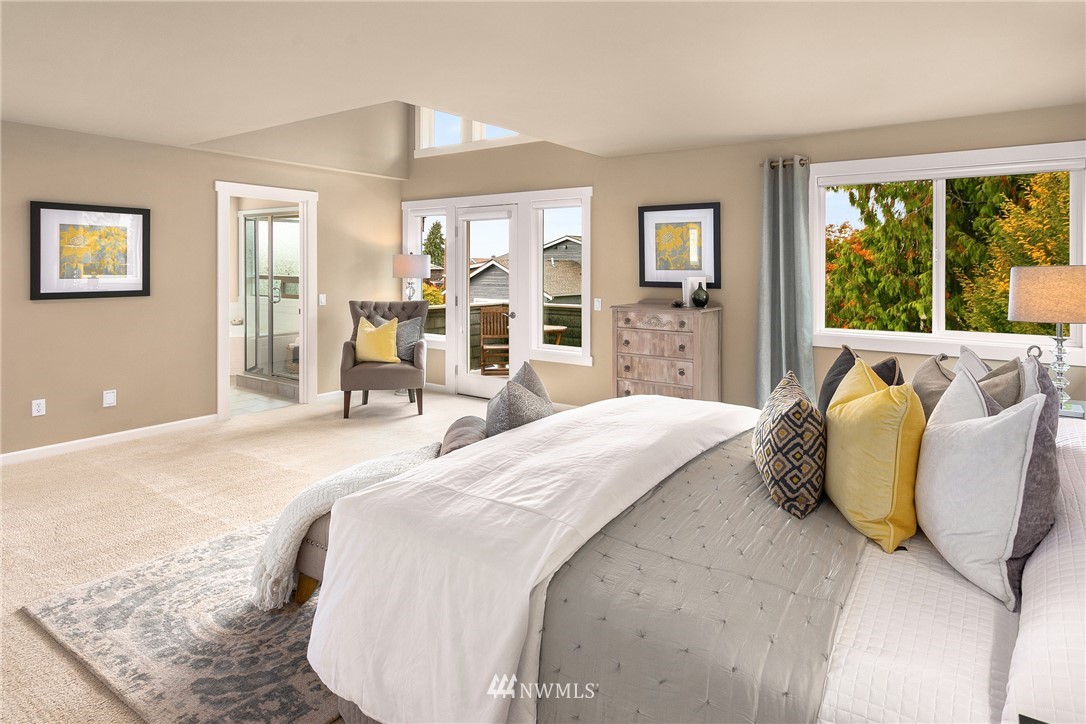 110 N 50th Street Seattle, WA 98103 - Photo 17 of 25 a spacious bedroom with a bed and glass windows