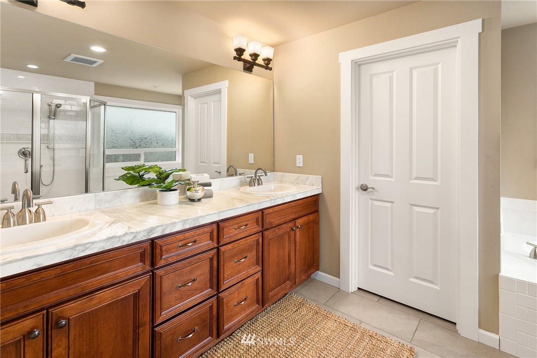 110 N 50th Street Seattle, WA 98103 - Photo 19 of 25 a spacious bathroom with a double vanity sink and a mirror