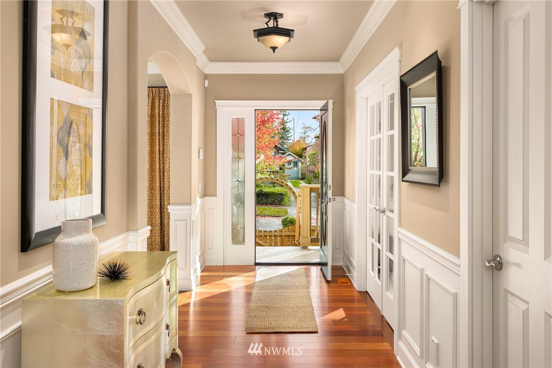 110 N 50th Street Seattle, WA 98103 - Photo 3 of 25 a view of a bedroom with wooden floor and windows