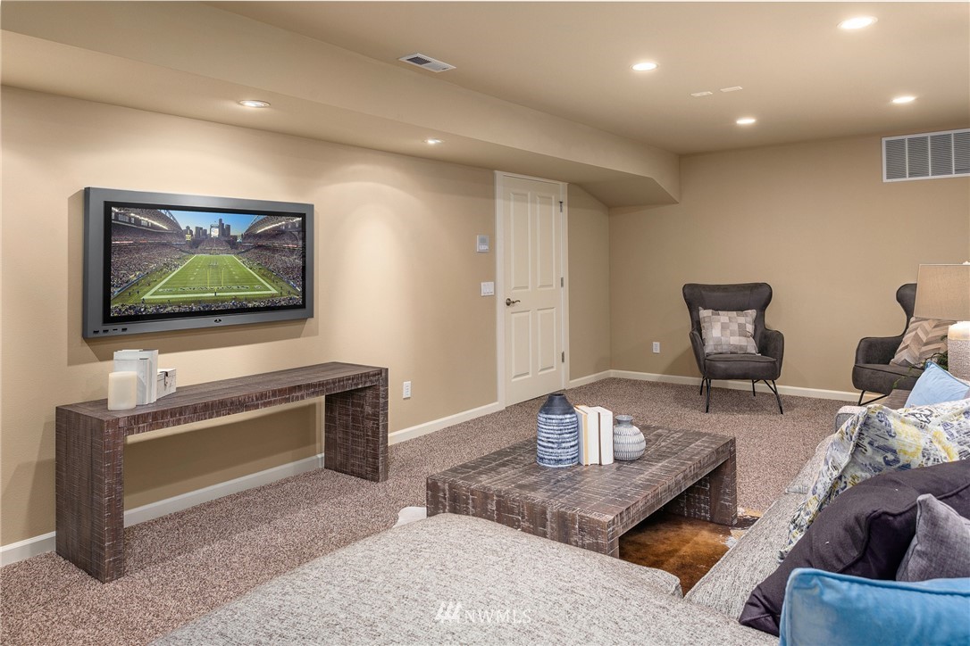 110 N 50th Street Seattle, WA 98103 - Photo 24 of 25 a living room with furniture and a flat screen tv