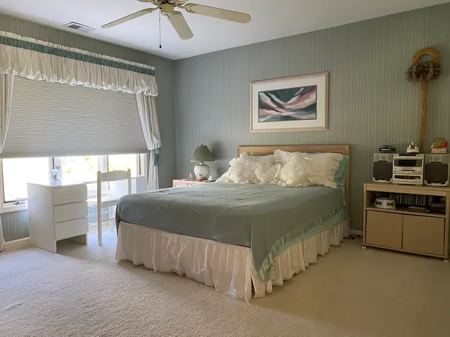 a room with pool table and windows