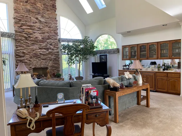 a living room with furniture and a large window