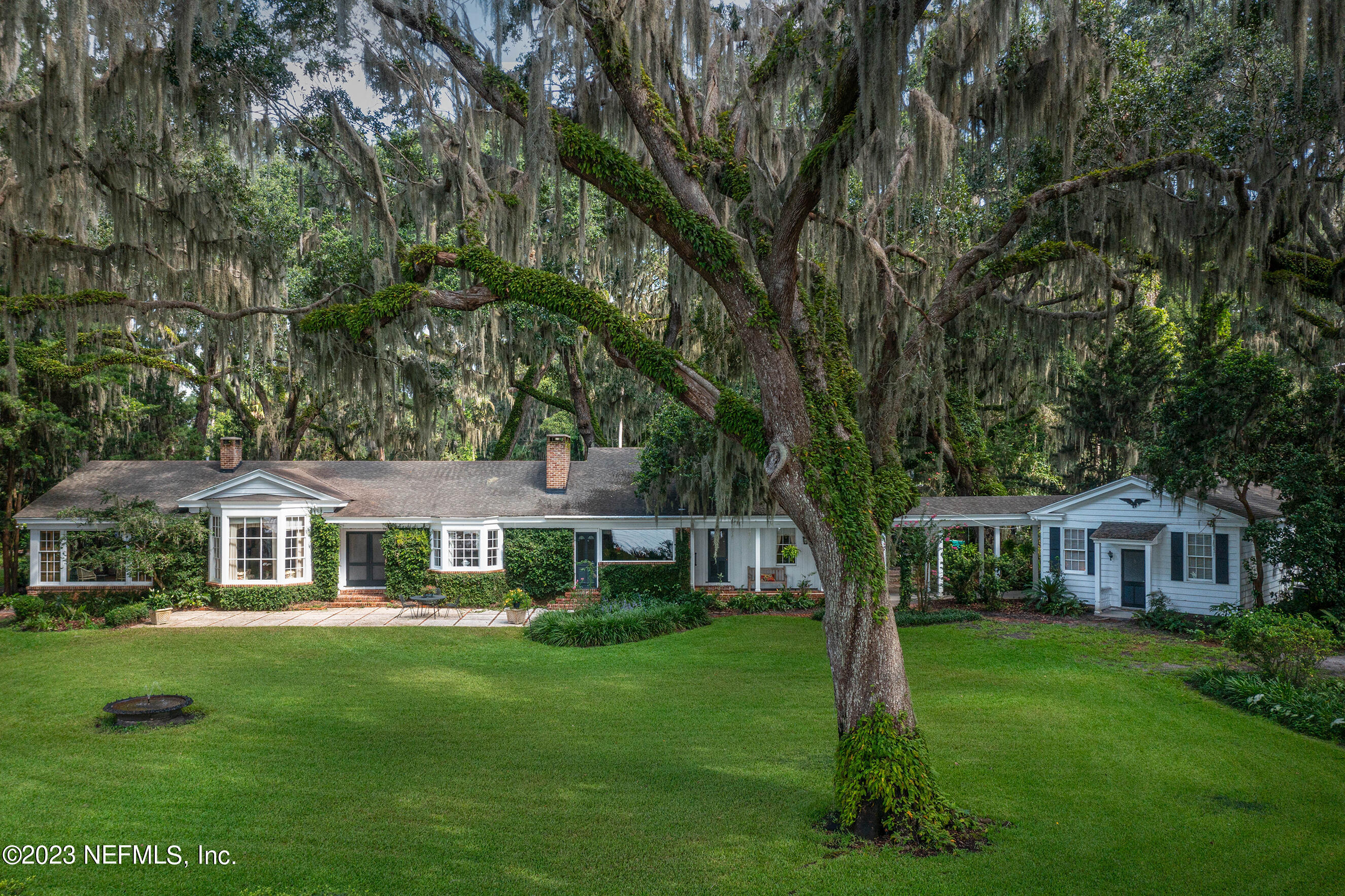6975 Old Church Road Fleming Island, FL 32003 - Photo 1 of 53 a front view of a house with a garden