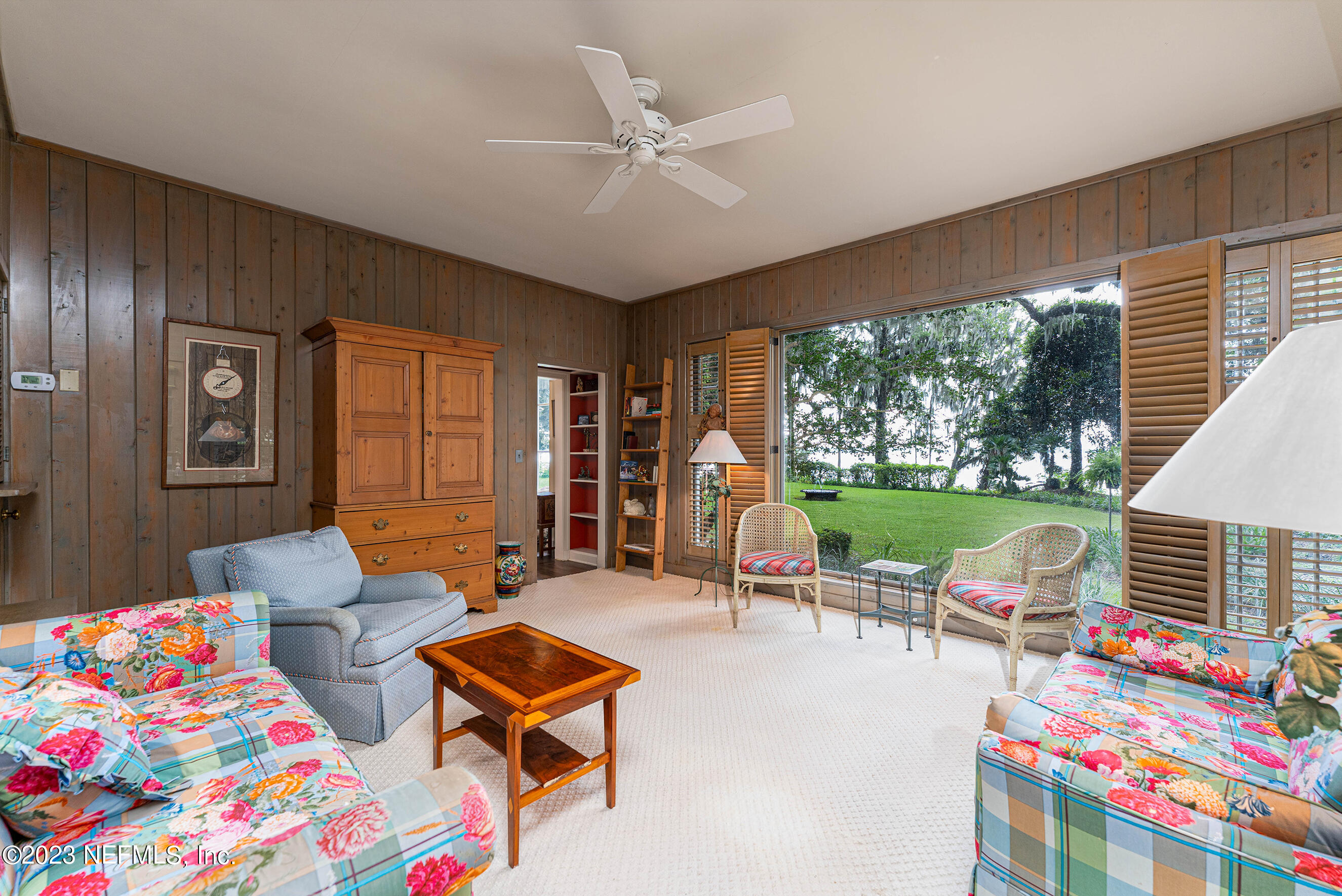 6975 Old Church Road Fleming Island, FL 32003 - Photo 15 of 53 a living room with patio furniture and a floor to ceiling window