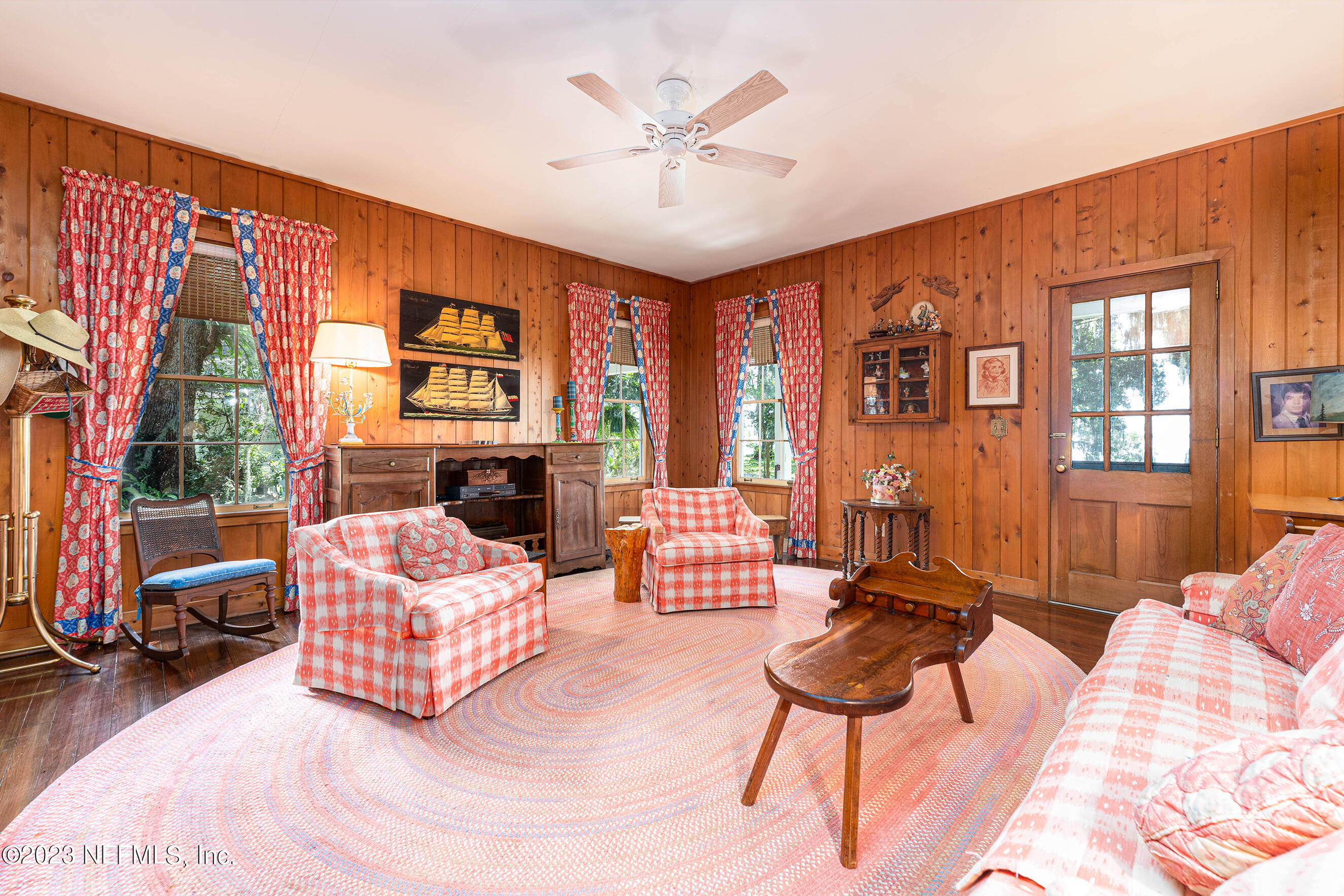 6975 Old Church Road Fleming Island, FL 32003 - Photo 22 of 53 a living room with furniture a fireplace and a large window