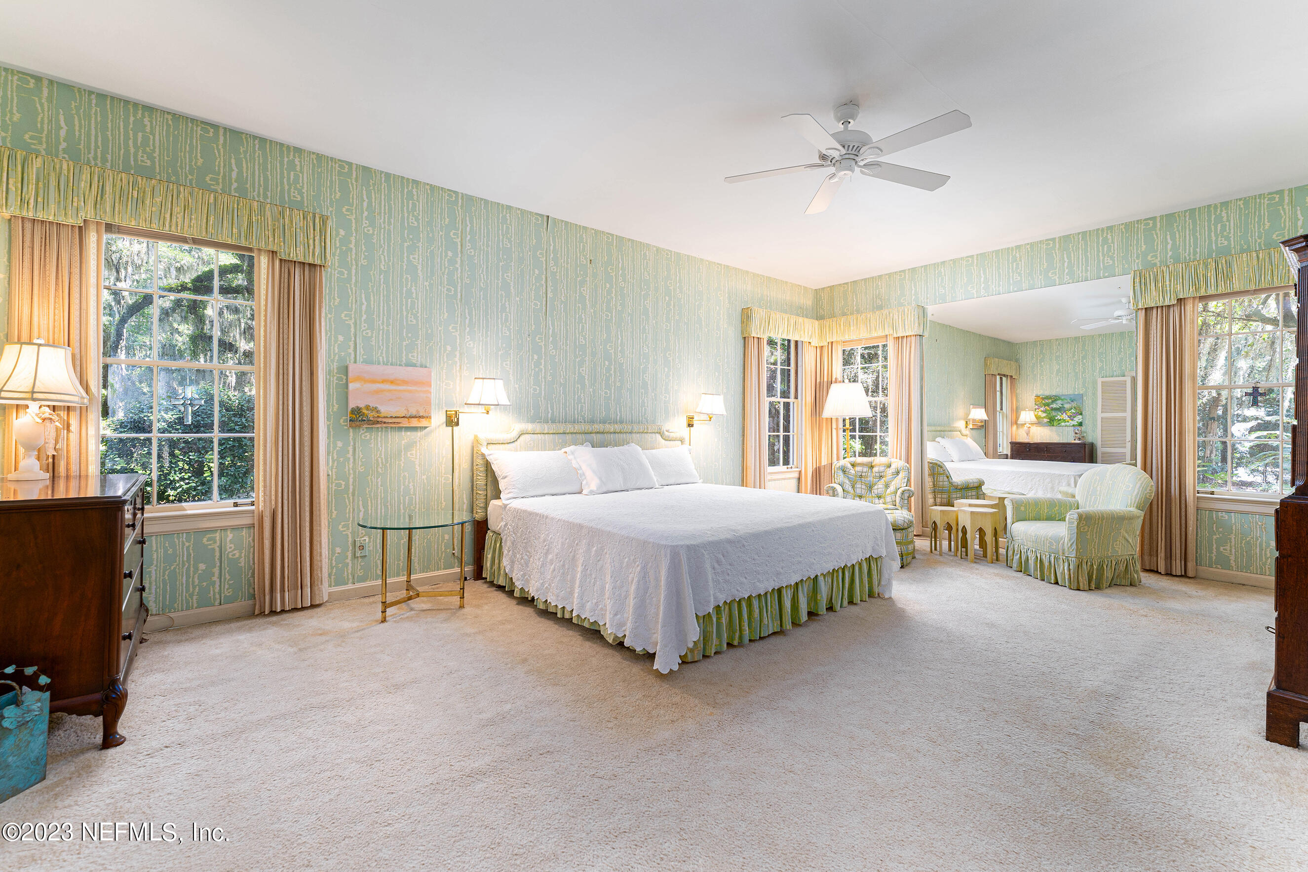 6975 Old Church Road Fleming Island, FL 32003 - Photo 24 of 53 a spacious bedroom with a bed and a chandelier
