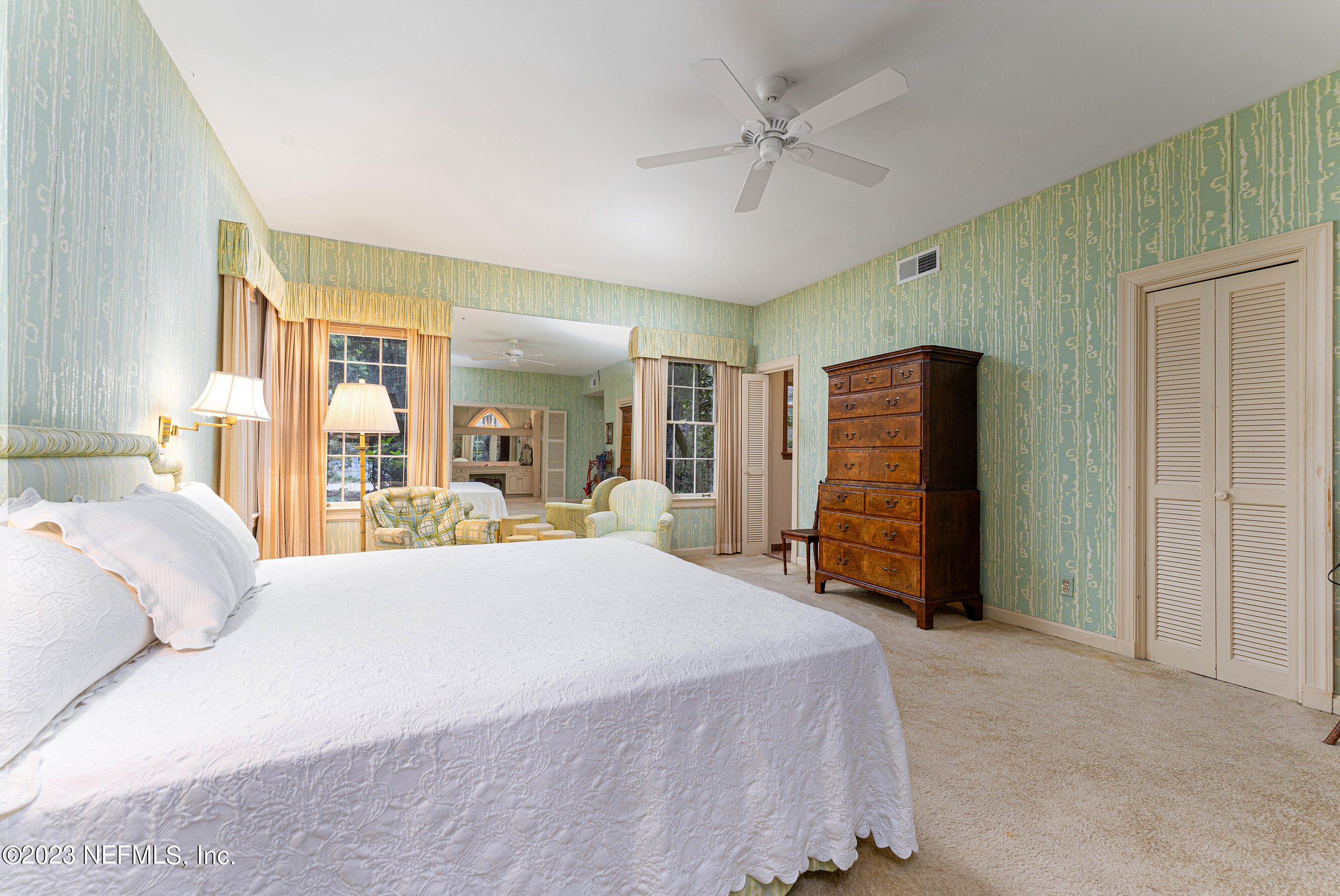 6975 Old Church Road Fleming Island, FL 32003 - Photo 25 of 53 a bed room with a bed and a large mirror