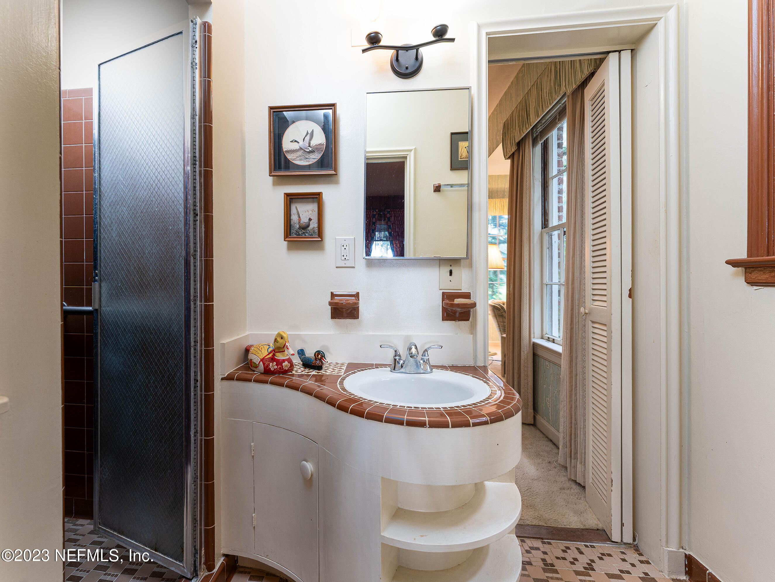 6975 Old Church Road Fleming Island, FL 32003 - Photo 29 of 53 a bathroom with a toilet a sink and a mirror