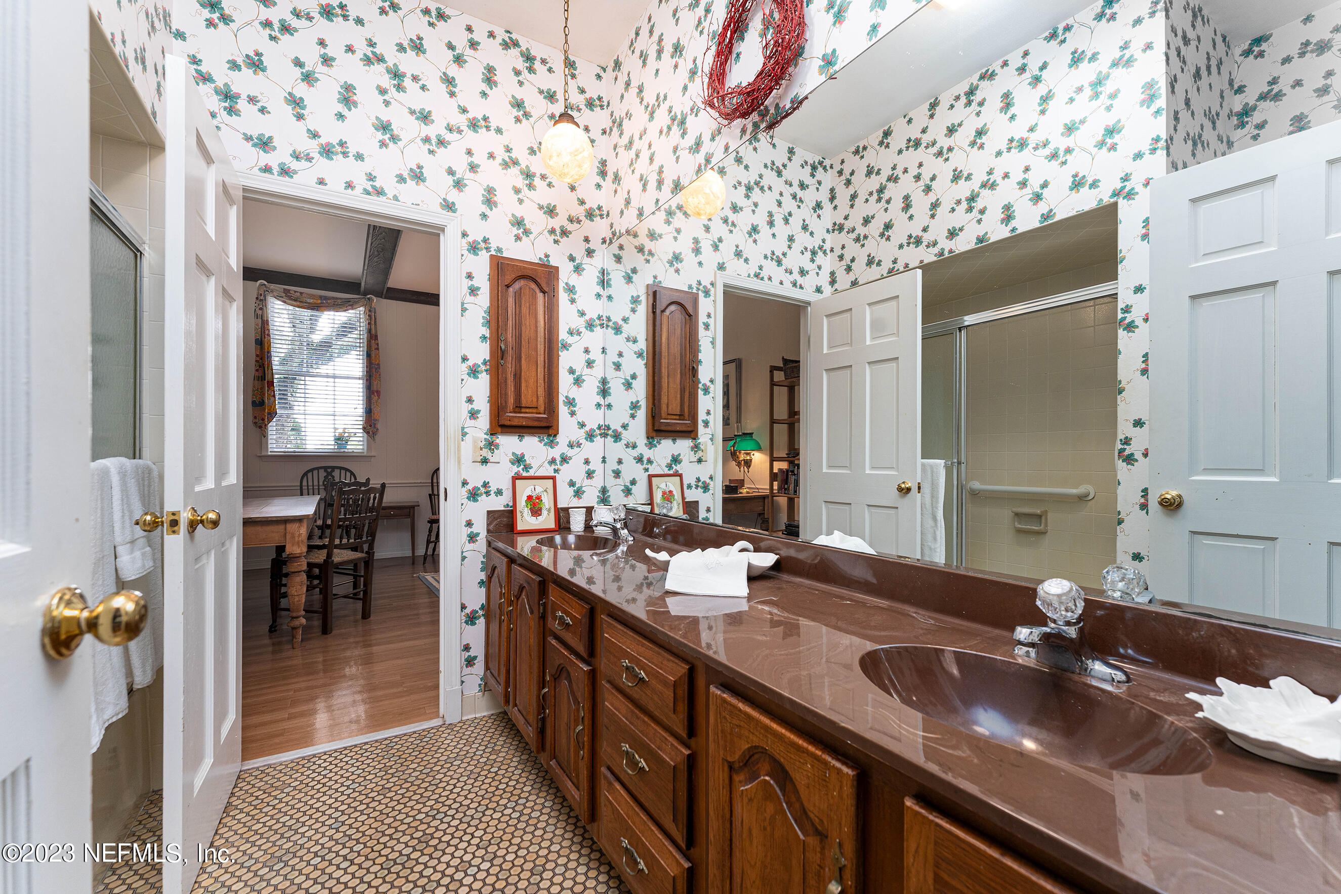 6975 Old Church Road Fleming Island, FL 32003 - Photo 32 of 53 a bathroom with a granite countertop sink a mirror and shower
