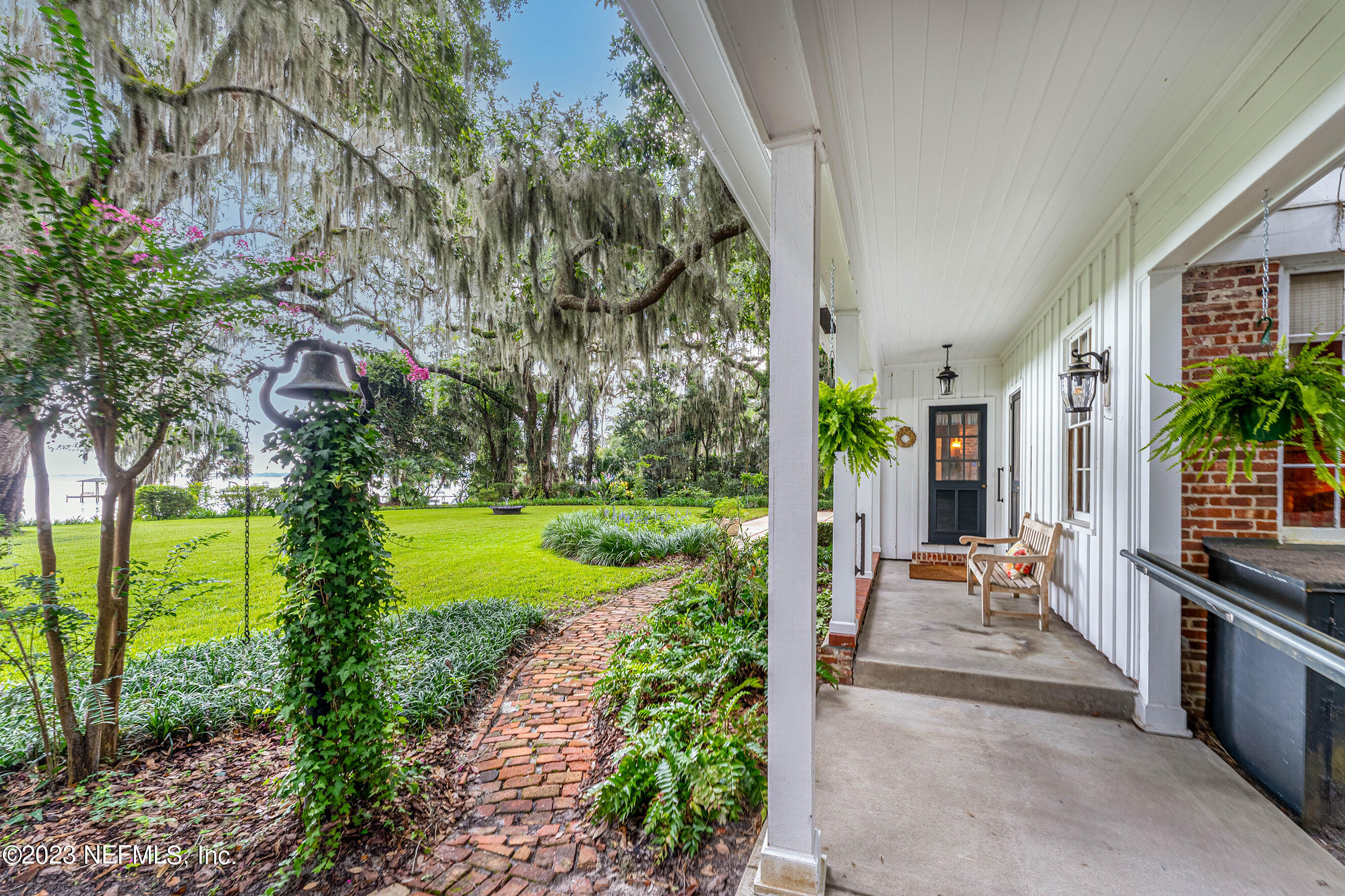 6975 Old Church Road Fleming Island, FL 32003 - Photo 36 of 53 a view of a patio with couches plants and large trees