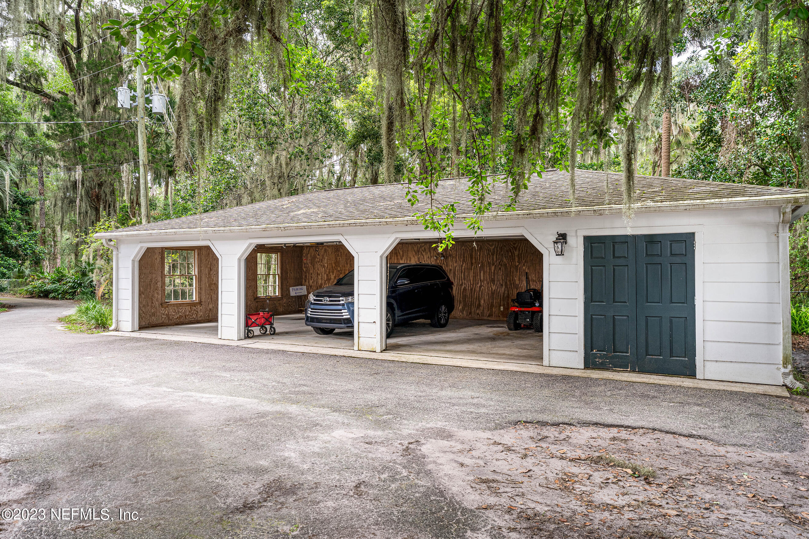 6975 Old Church Road Fleming Island, FL 32003 - Photo 42 of 53 a view of a house with a garage and yard