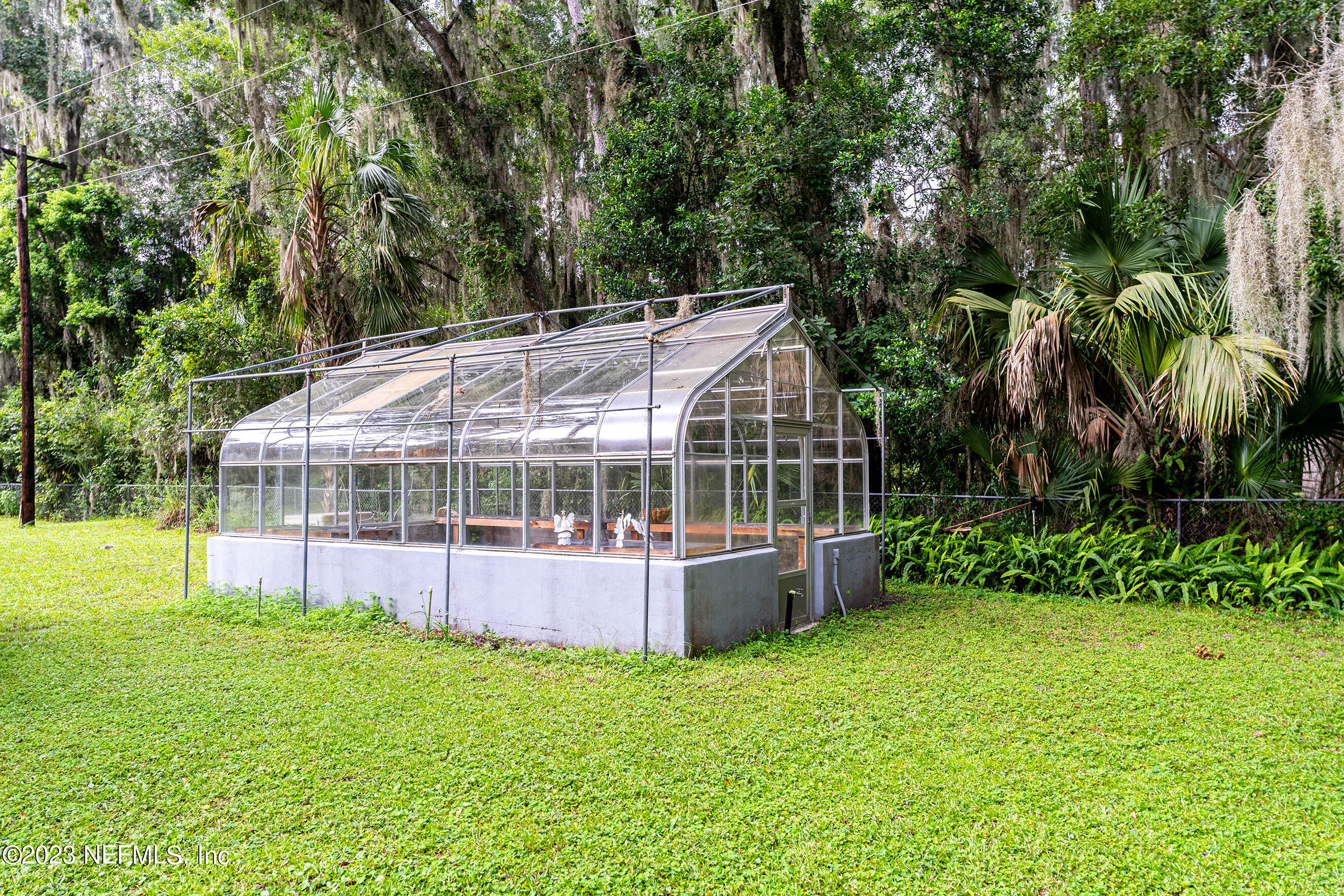6975 Old Church Road Fleming Island, FL 32003 - Photo 49 of 53 a view of a house with a backyard and a patio