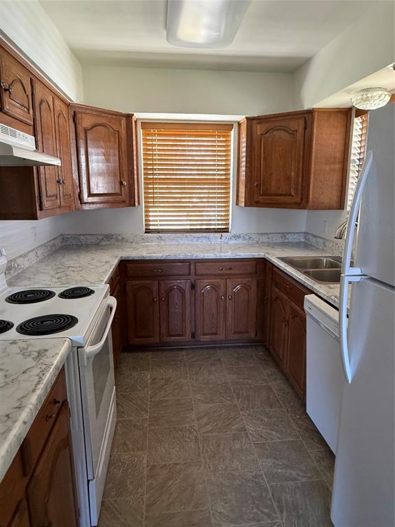 902 North 4th Street Wills Point, TX 75169 - Photo 14 of 15 a kitchen with stainless steel appliances granite countertop a stove a sink and a microwave