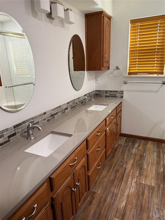 902 North 4th Street Wills Point, TX 75169 - Photo 5 of 15 a bathroom with a sink and a mirror