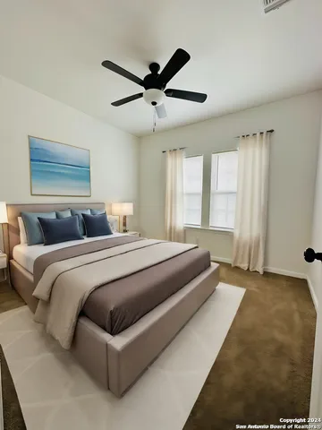 a bathroom with a granite countertop toilet a sink and a mirror