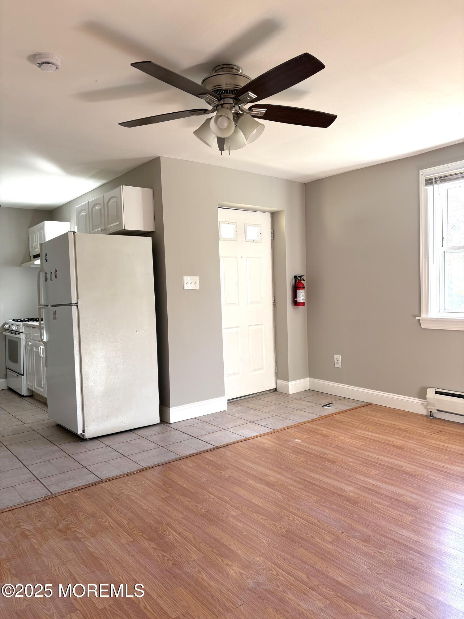 672 Shore Concourse, Unit B Keyport, NJ 07735 - Photo 4 of 10 a view of a livingroom with wooden floor and a ceiling fan