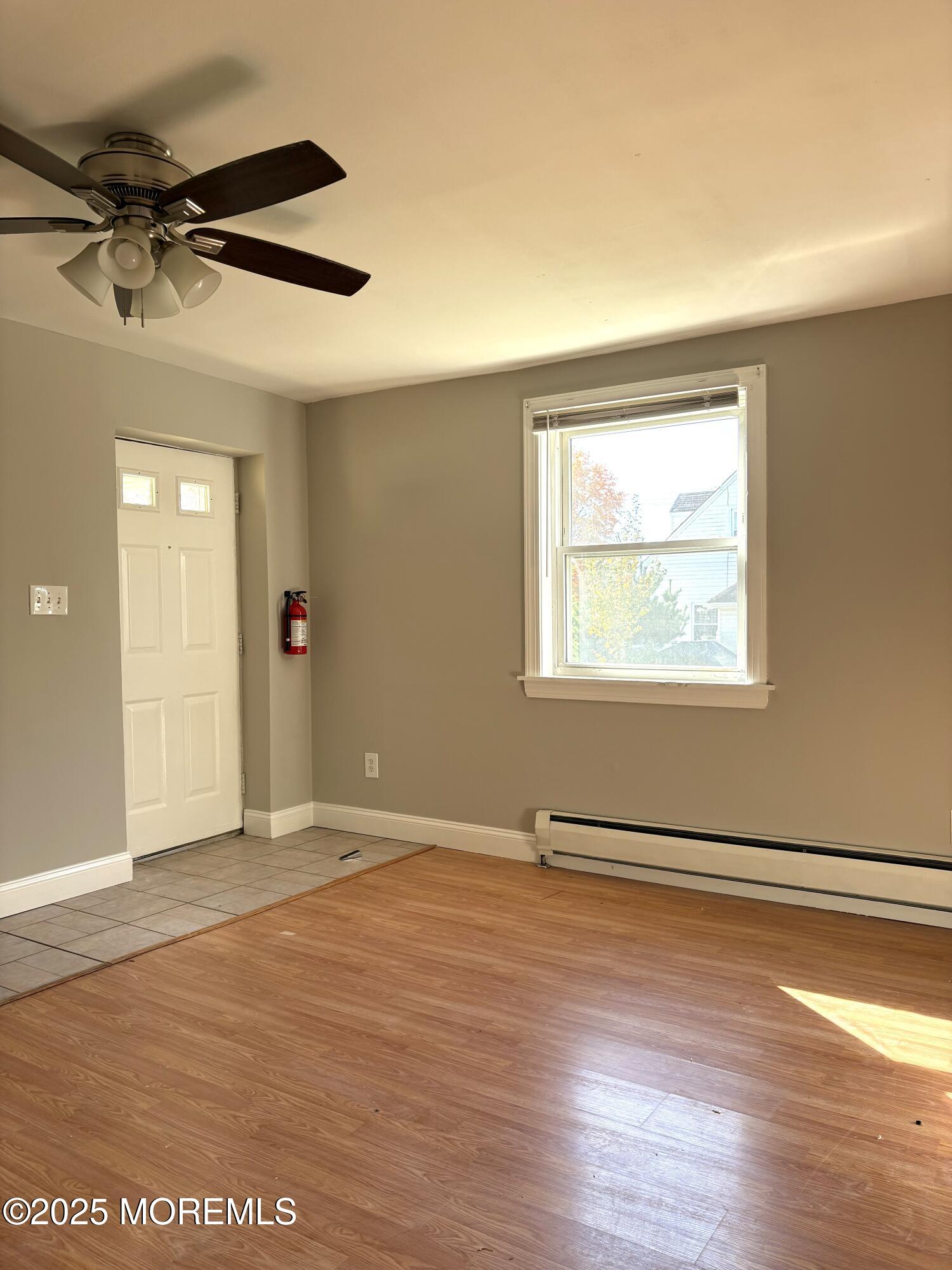 672 Shore Concourse, Unit B Keyport, NJ 07735 - Photo 6 of 10 an empty room with wooden floor closet and windows