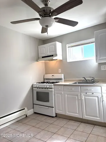 a kitchen with cabinets and stainless steel appliances