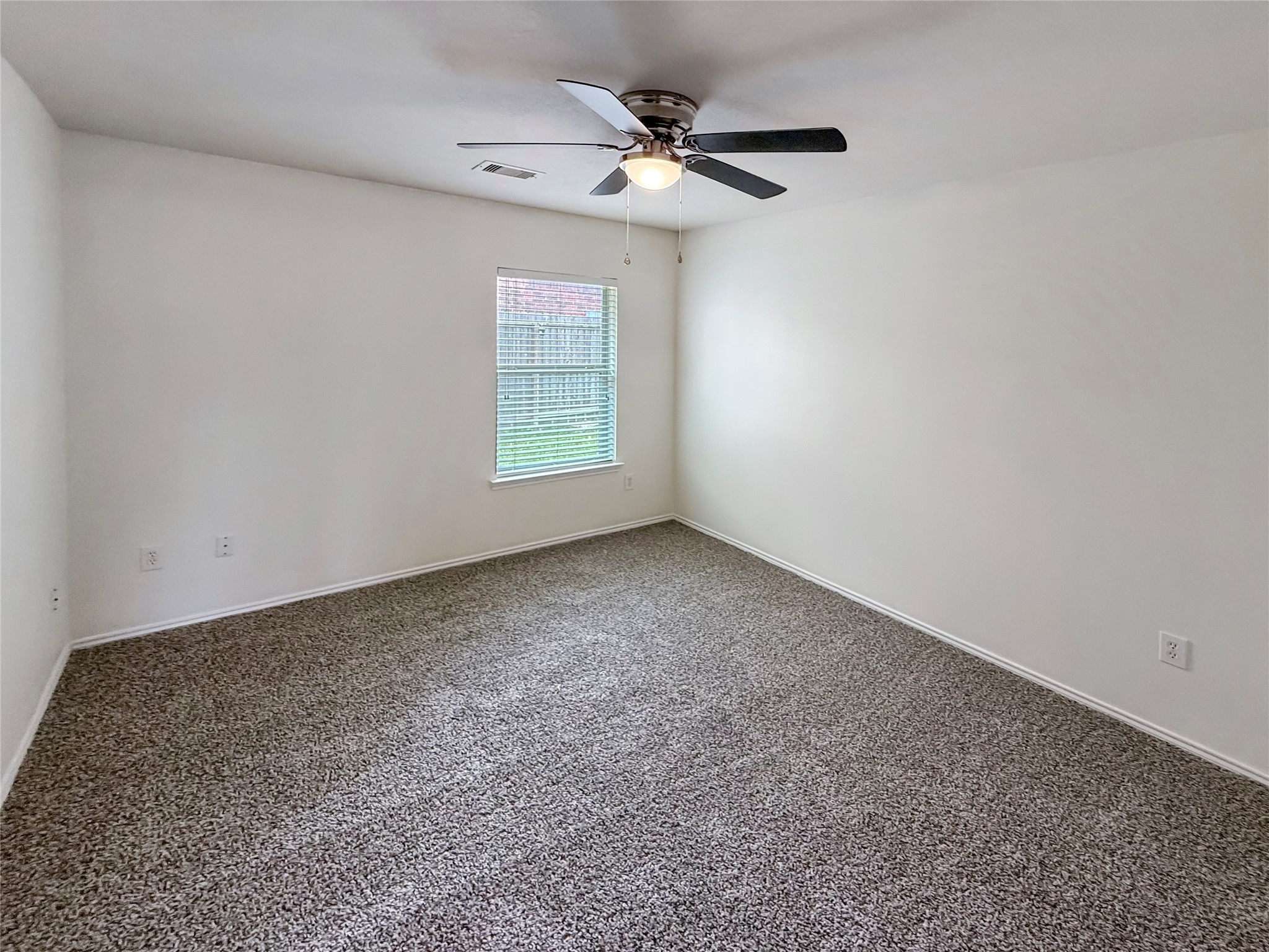 19531 Village Of Bridgestone Lane Spring, TX 77379 - Photo 28 of 40 an empty room with a window and a fan