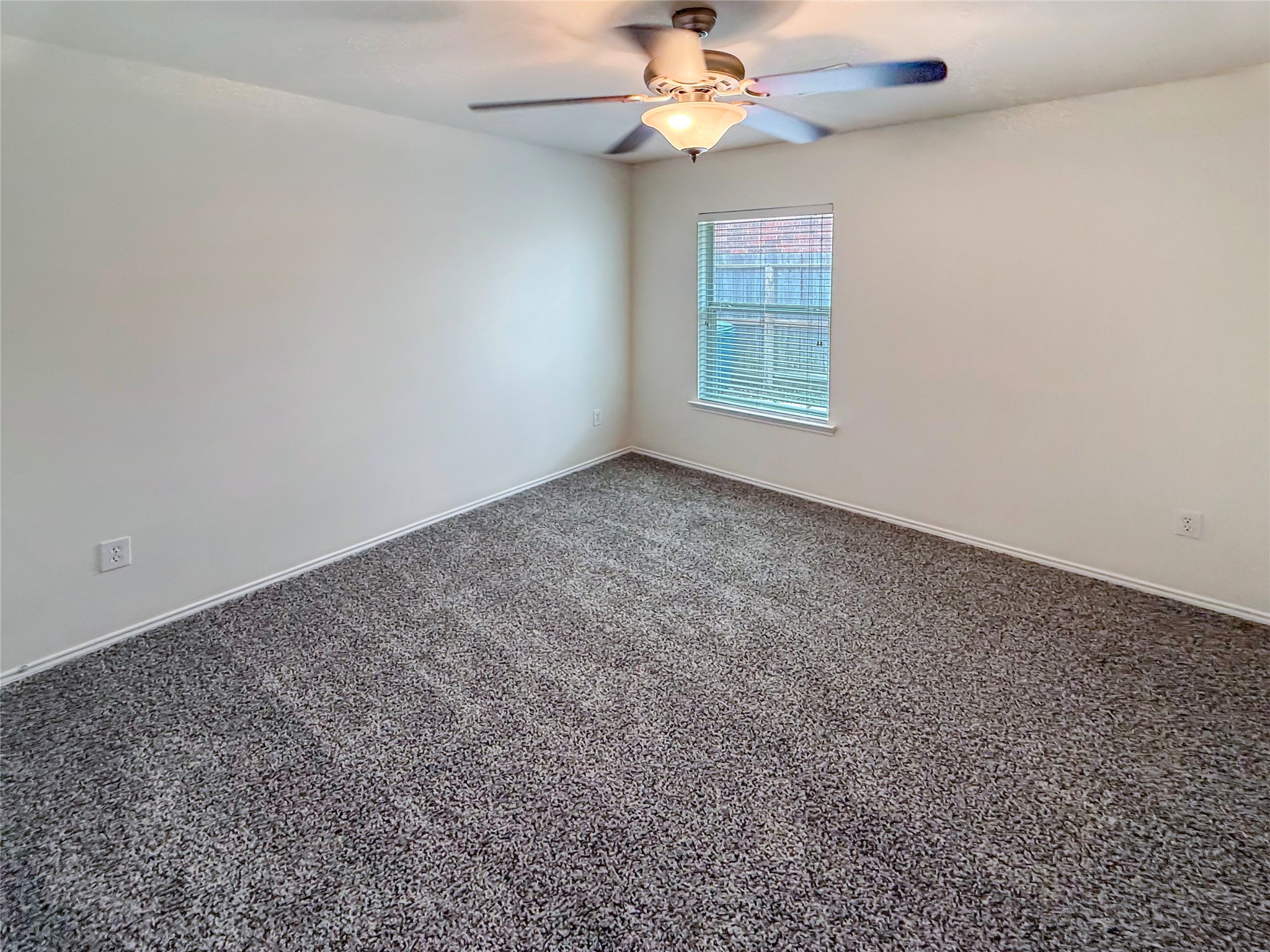 19531 Village Of Bridgestone Lane Spring, TX 77379 - Photo 30 of 40 an empty room with windows and fan