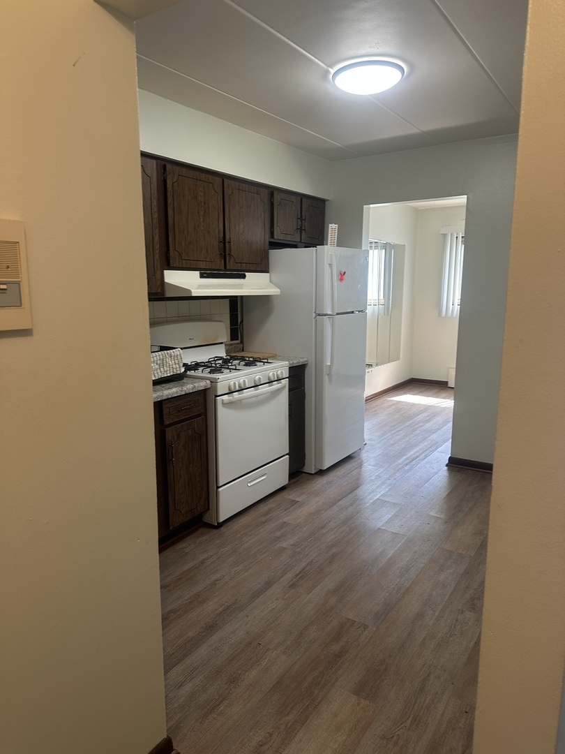 18550 Torrence Avenue, Unit 4 Lansing, IL 60438 - Photo 14 of 14 a kitchen with stainless steel appliances a stove a refrigerator and a microwave