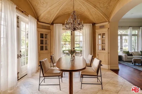 a dining room with furniture and wooden floor