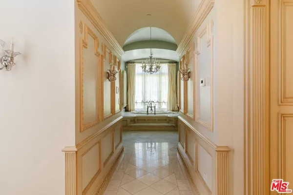a large white kitchen with a large window