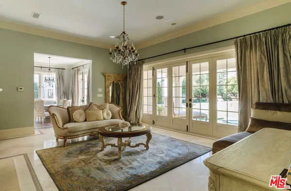 a living room with furniture and a chandelier