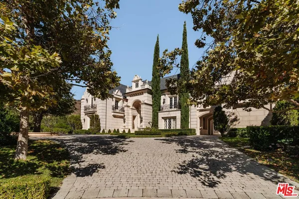 an aerial view of a house with a swimming pool