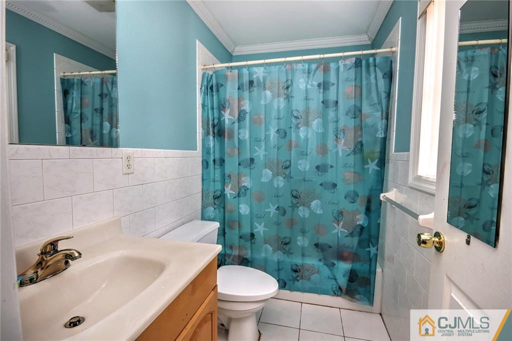 18 Harvard Road Old Bridge, NJ 08859 - Photo 11 of 24 a bathroom with a sink a toilet a mirror and shower