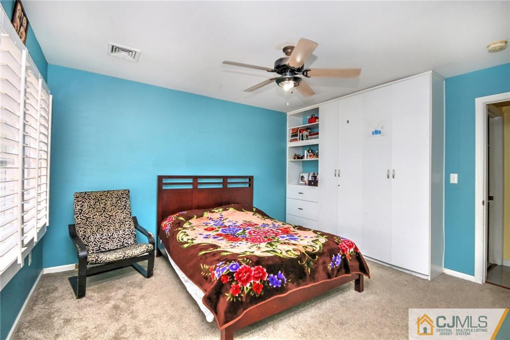 18 Harvard Road Old Bridge, NJ 08859 - Photo 12 of 24 a bedroom with a bed and a chandelier