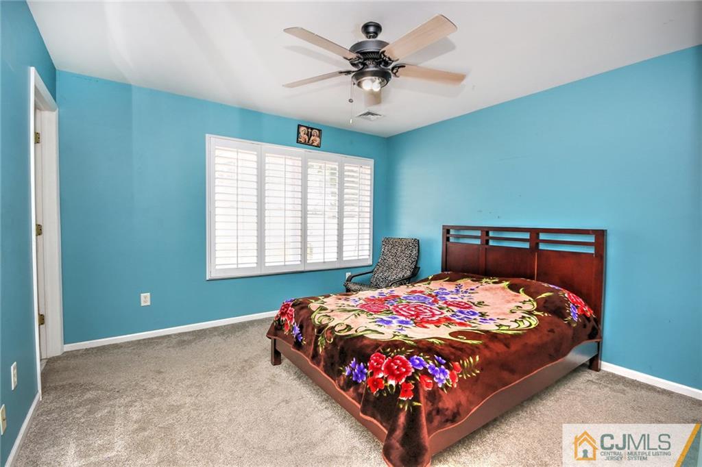 18 Harvard Road Old Bridge, NJ 08859 - Photo 13 of 24 a bedroom with a bed and a chandelier