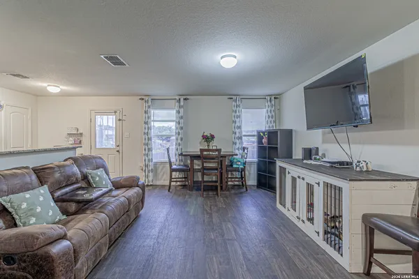 a living room with furniture and a wooden floor