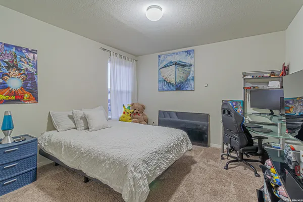 a bedroom with a bed and a desk