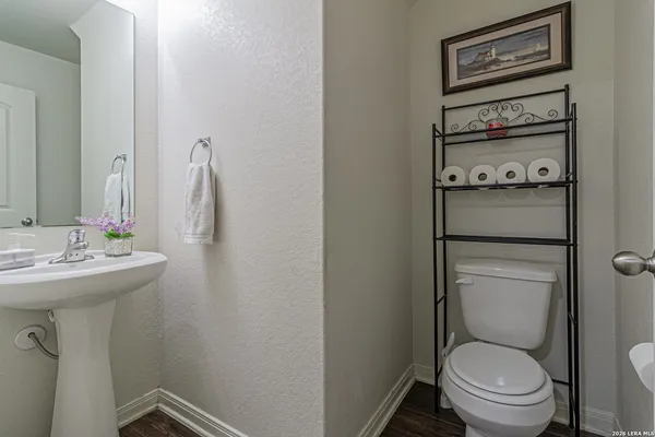 a bathroom with a sink a toilet and a mirror