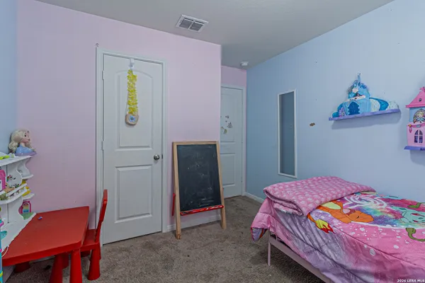 a bedroom with a bed and a desk
