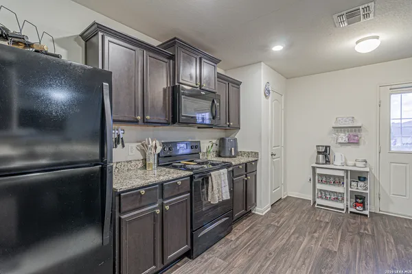 a kitchen with stainless steel appliances granite countertop a stove and a refrigerator