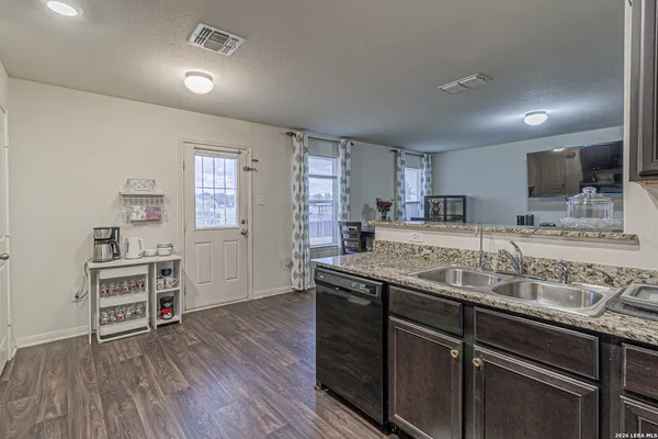a kitchen with stainless steel appliances granite countertop a sink stove and cabinets