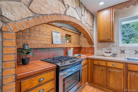 a kitchen with stainless steel appliances granite countertop a stove a sink dishwasher and cabinets