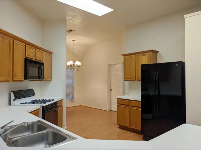 a kitchen with a refrigerator sink and microwave