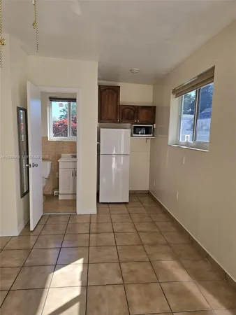 a view of a kitchen with a sink and a refrigerator