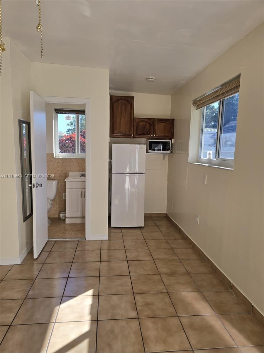 15764 Southwest 303rd Terrace Homestead, FL 33033 - Photo 3 of 14 a view of a kitchen with a sink and a refrigerator