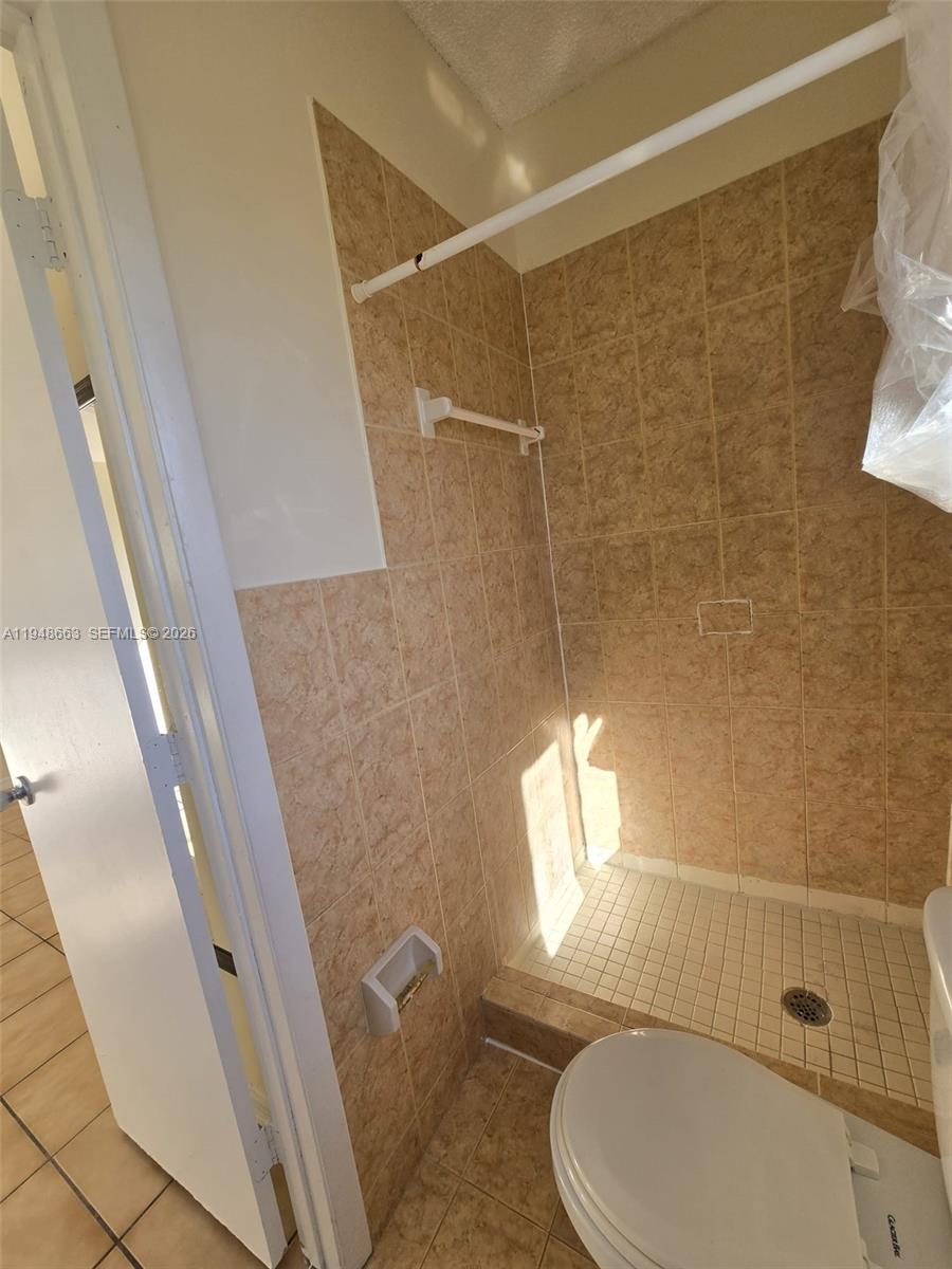 15764 Southwest 303rd Terrace Homestead, FL 33033 - Photo 8 of 14 a bathroom with a toilet and shower