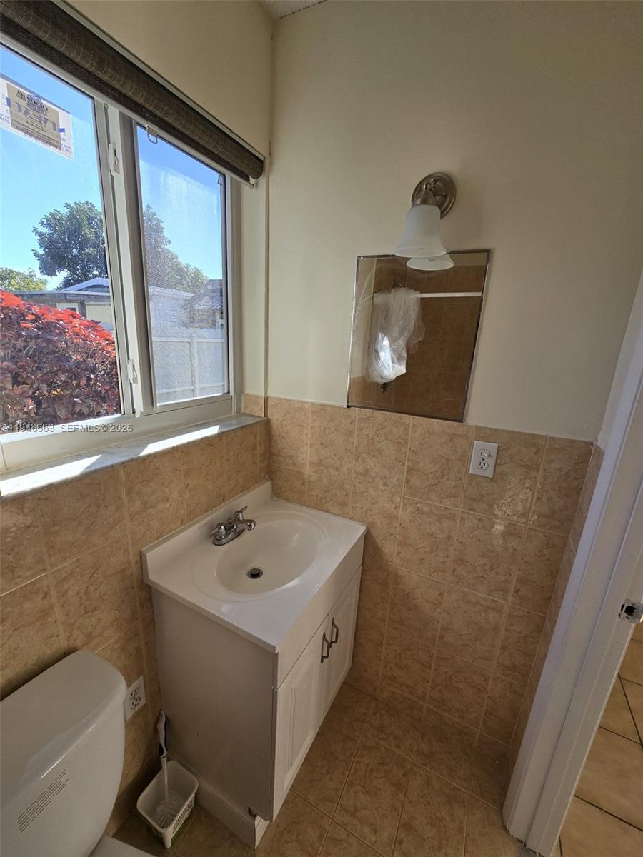 15764 Southwest 303rd Terrace Homestead, FL 33033 - Photo 9 of 14 a bathroom with a sink and a mirror