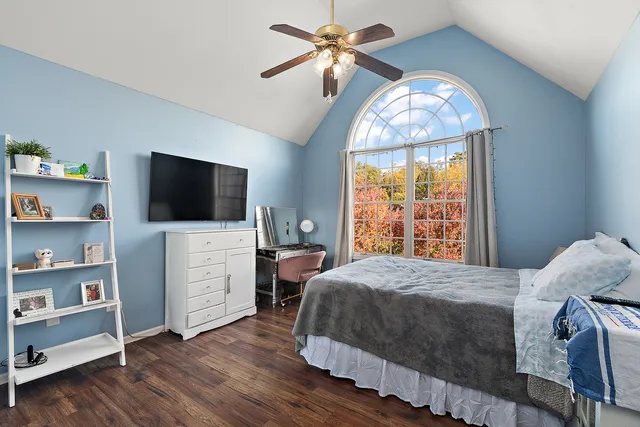 a bedroom with a bed and a flat screen tv