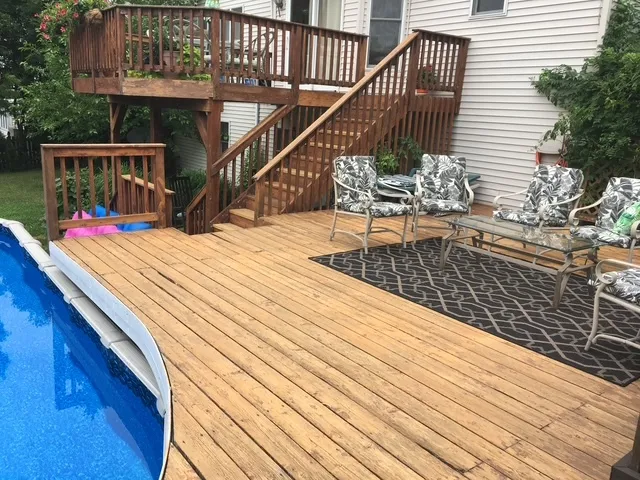 a view of a balcony with two chairs and a stove